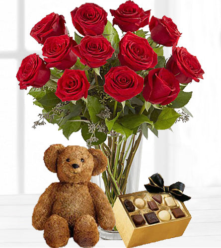 The Ultimate Valentine's Gift - Twelve Vased Red Roses with Chocolates & Brown Bear - the name says it all.
