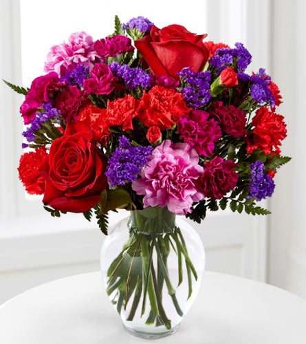 Sweethearts Bouquet in a Clear Vase - arrangement of red. pink and purple mixed flowers in a clear glass vase.