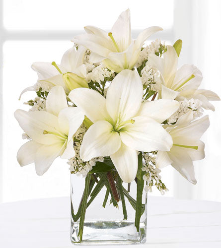 Lush Lily Bouquet - arrangement of white lilies in a clear vase.