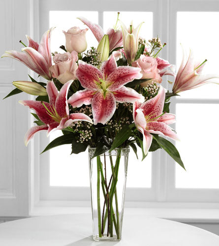 Simple Perfection by Better Homes & Gardens - Bouquet of pink lilies and roses in a clear vase.