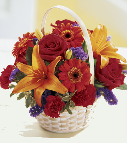 Fun in the Sun Basket - colourful flower arrangement in a white woven basket.