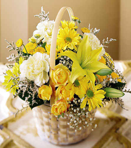 Flourishing Garden Basket - arrangement of yellow and white flowers in a white woven basket.