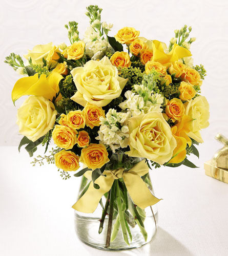 Golden Splendour Bouquet - arrangement of yellow and white roses in a clear vase with a cream coloured ribbon.