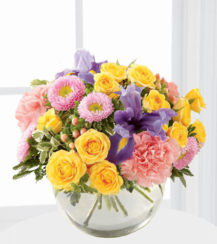 FTD's New Dream Bouquet - colourful flower arrangement in a glass bubble bowl.