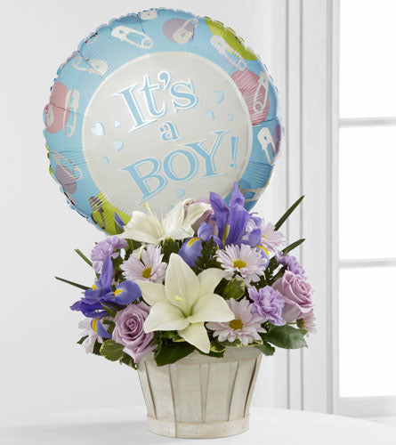 FTD's Boys Are Best! Arrangement - blue, purple and white floral arrangement in a white basket with a 'It's a Boy!' balloon attached.