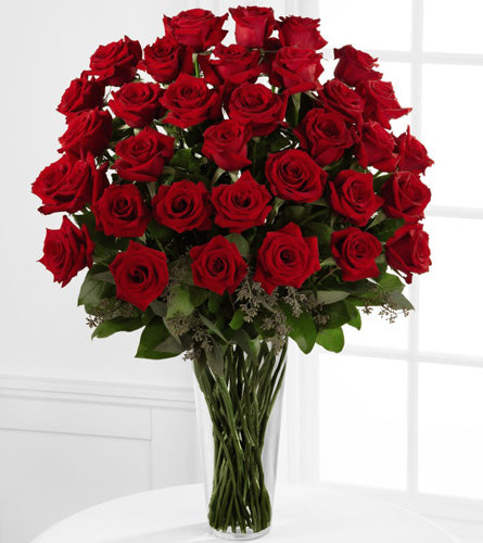 Exquisite Red Rose Bouquet - arrangement of thirty six red roses with greenery in a clear vase.