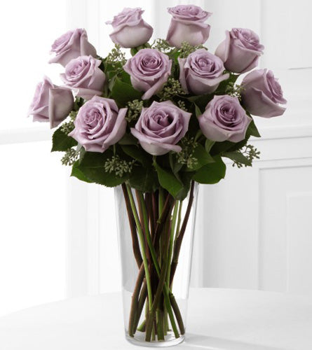 Lavender Rose Bouquet - arrangement of twelve purple roses with greenery in a clear vase.