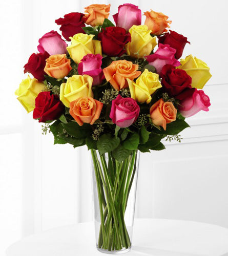 Premium Bright Spark Rose Bouquet - arrangement of mixed colourful roses with greenery in a clear vase.