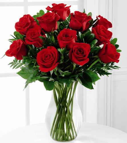 FTD's Blooming Masterpiece Rose Bouquet - a dozen red roses in a clear vase.