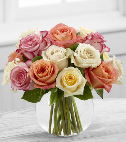 FTD's Sundance Rose Bouquet - floral design of cream, white, orange and pink roses in a clear bubble bowl vase.