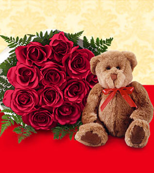 One Dozen Wrapped Red Roses & Large Bear - Bouquet of a dozen red roses with a teddy bear wearing a red bow.