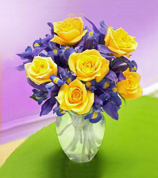 Iris & Yellow Rose Bouquet - floral design of yellow roses and blue iris in a clear vase.