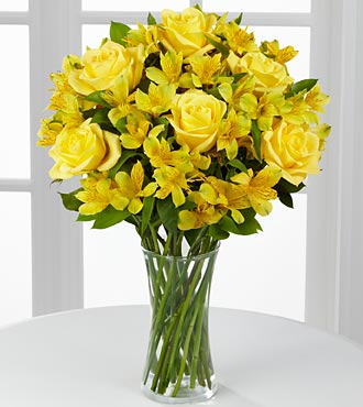Citrus Burst Bouquet - floral arrangement of yellow roses and alstroemeria in a clear glass vase.