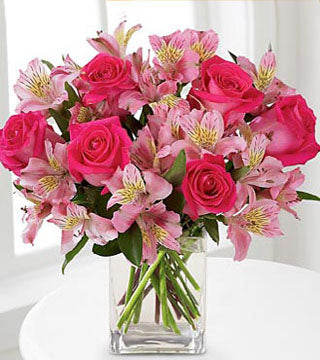 Dreamland Bouquet - arrangement of pink roses and alstroemeria in a clear glass vase.