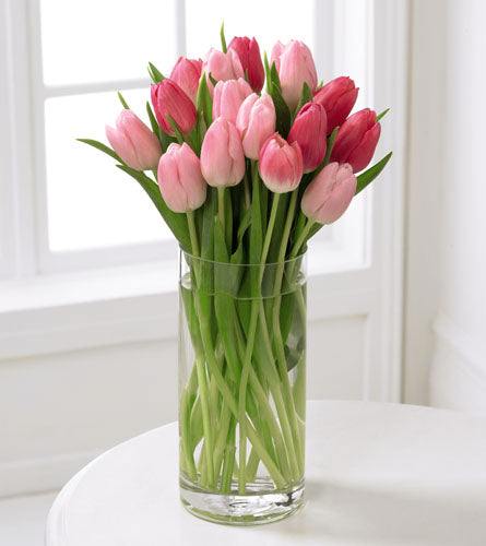 FTD's Deluxe Tender Tulips Bouquet - floral arrangement of pink tulips in a clear glass vase.