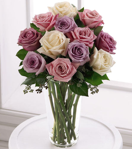Pastel Rose Bouquet - Bouquet of pink, purple, and white roses in a clear glass vase.