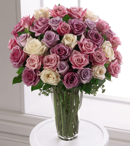 Exquisite Pastel Rose Bouquet - arrangement of pink, purple, and white roses in a clear glass vase.