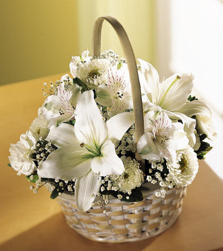 Divinity Basket - floral arrangement of mixed white flowers in a woven basket.