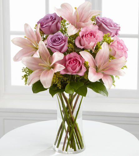 Farewell Too Soon Bouquet - arrangement of pink and purple flowers in a clear vase.