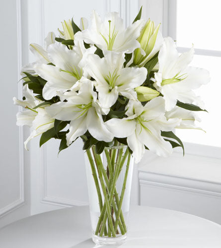 Light in Your Honour Bouquet - arrangement of white lilies in a clear glass vase.
