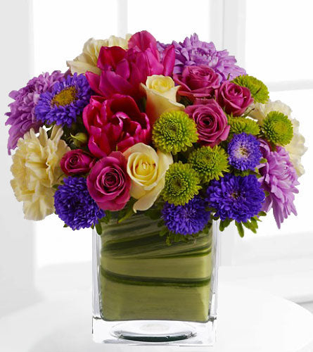 Teleflora's One Fine Day - colourful flower bouquet in a clear glass cube.