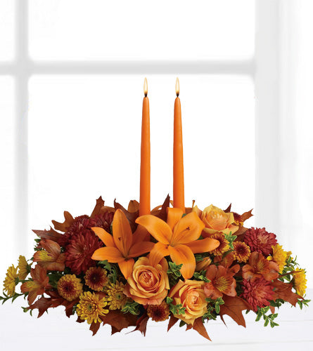 Family Gathering Centrepiece - decorative floral arrangement with orange candles.