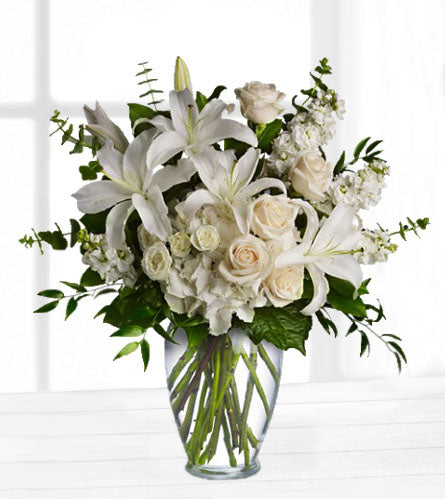 Dreams From the Heart Bouquet - floral arrangement of white flowers in a clear glass vase.