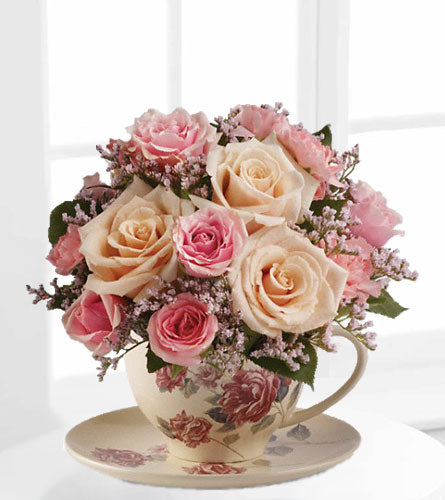 Teleflora's Victorian Teacup Bouquet - floral arrangement in a teacup with pink and white roses with wax flowers.