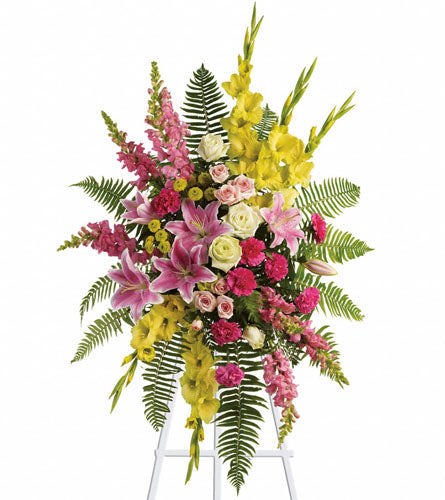 Rays of Light Spray - colourful floral arrangement with pink, yellow, and green flowers on a stand.