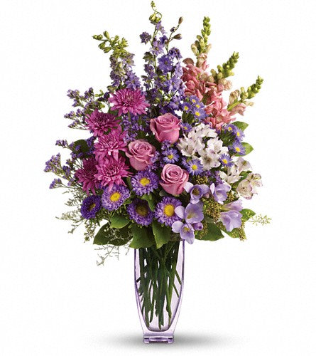Steal the Show by Teleflora - bouquet of colourful flowers in a clear vase.