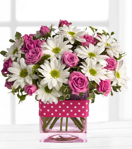 Teleflora's Polka Dots and Posies - Bouquet of pink roses and white daisies in a clear glass vase with a pink polka dot ribbon.