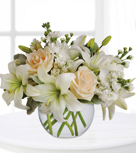 Isle of White - floral arrangement with white and peach flowers in a decorative vase.