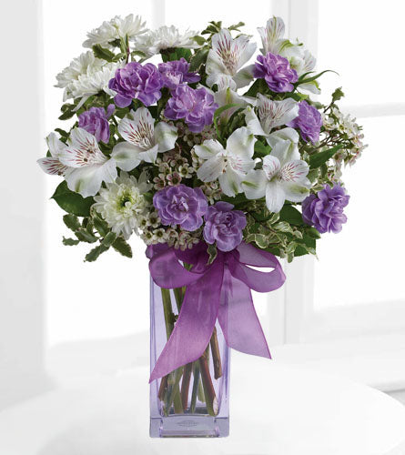 Lavender Laughter - arrangement of white and purple flowers in a lavender vase with bow.