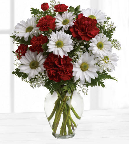 Kindest Heart Bouquet - red carnations, red mini carnations, white daisies and baby's breath arranged in a clear glass vase.