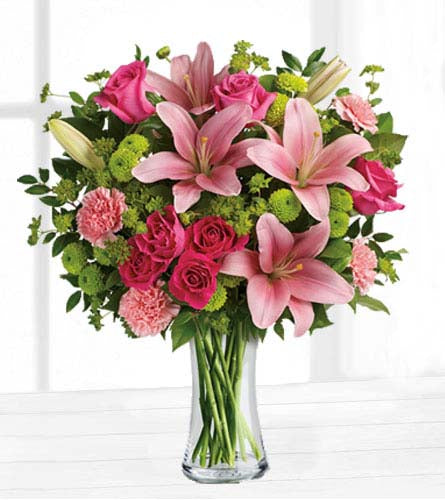 Dress to Impress Bouquet - pink lilies, roses and carnations arranged with green pom mums in clear glass vase.