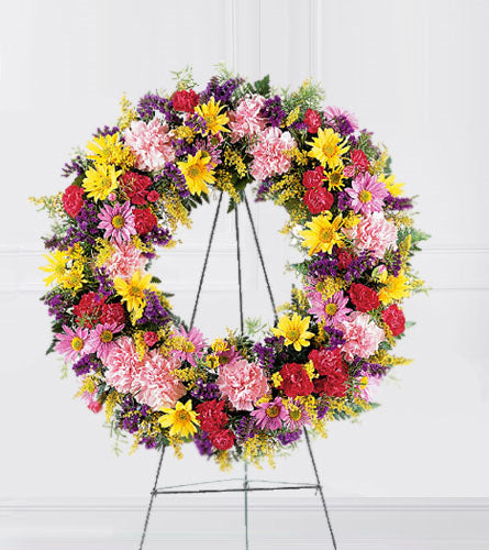 Eternity Wreath - colourful mixed flower wreath on a stand.