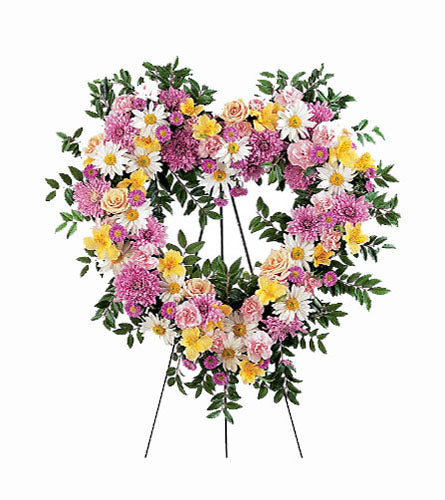 Loving Heart Tribute - floral arrangement with colourful mixed flowers shaped like a heart on a stand.