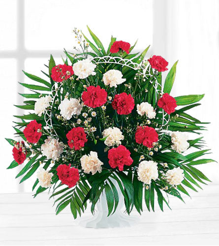 Hope and Honour Basket - floral arrangement with red and white flowers with greenery in a white basket.