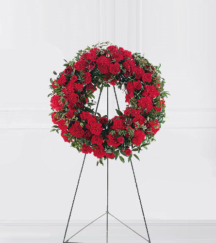 Red Regards Wreath - red floral wreath on a stand.