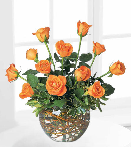 A Dozen Orange Roses - bouquet of twelve orange roses in a decorative vase.