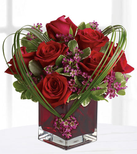 Sweet Thoughts Deluxe - Heart-shaped arrangement of red roses and greenery in a red cube vase.