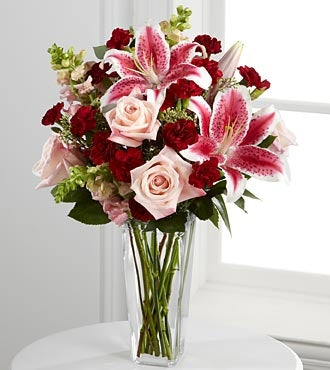 More Than Love Bouquet - colourful arrangement of red, purple and pink flowers in a clear glass vase.