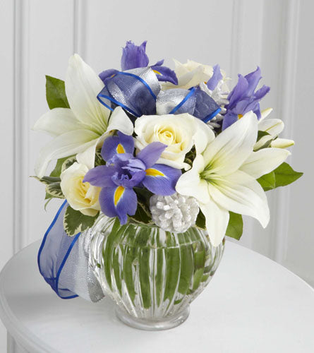 Miracle's Light Bouquet - arrangement of white and blue flowers in a clear vase.