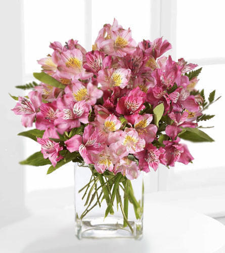 Pink Persuasion Bouquet - arrangement of pink flowers in a clear glass vase.