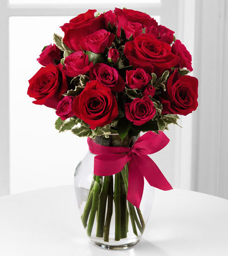 Love-Struck Rose Bouquet - arrangement of red roses in a clear vase with a pink ribbon.