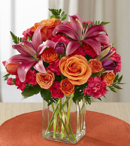 FTD's Always True Bouquet - floral design of pink and orange flowers in a clear rectangular vase.