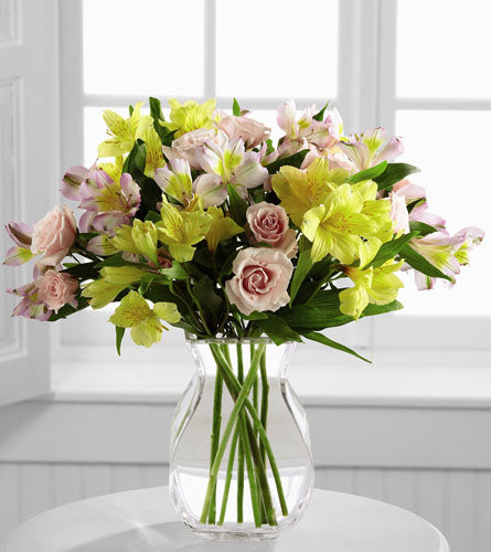 Breathtaking Beauty by Better Homes & Gardens - bouquet of pink. yellow and white flowers in a clear vase.
