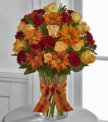 The Golden Autumn Bouquet - peach spray roses, burgundy mini carns and  butterscotch chrysanthemums in a clear vase.