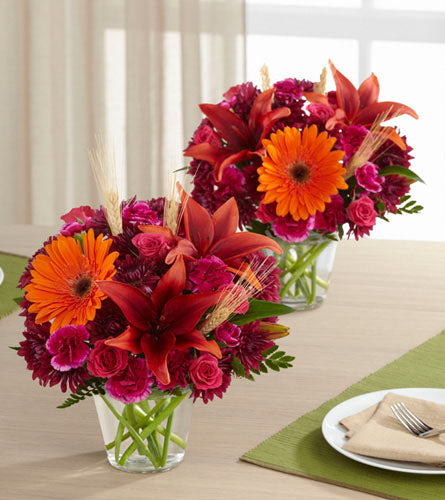 Bountiful Garden Duo - Two vibrant flower bouquets with red, orange, and pink flowers in clear glass vases.