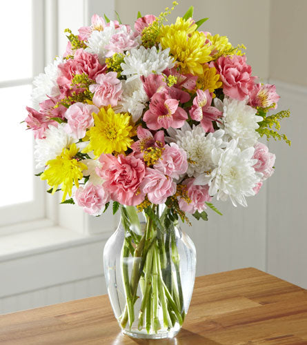 Sweeter than Ever - Bouquet of pink, yellow, and white flowers in a clear vase.